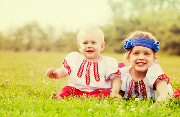 children in russian folk clothes on grass