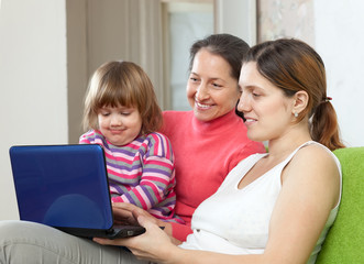 Fototapeta na wymiar Family of three generations using laptop