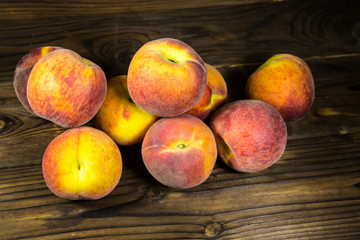 Fototapeta na wymiar Ripe peaches on wooden table