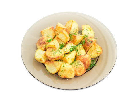 Fried potatoes with dill on dark glass dish