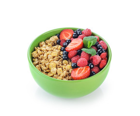 Muesli with fresh berries in a bowl isolated on white background.