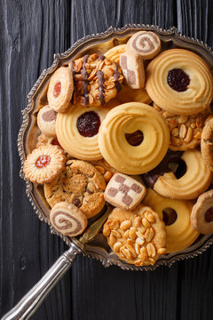 Biscuit mix with various fillings on a plate, vertical view from above
