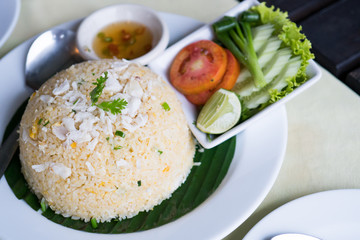 Crab fried rice with vegetables on white plate.