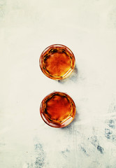 Golden alcohol drink in a glasses, top view