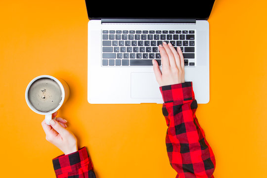 Businesswoman hands with laptop and cup of coffee