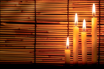 Group of candle light on blurred old wooden background at the night. Selective focus on tha candle with soft  light effect.