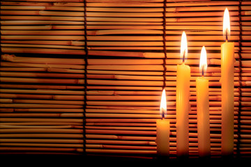 Group of candle light on blurred old wooden background at the night. Selective focus on tha candle...