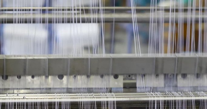 Industrial knitting machine producing cotton yarn