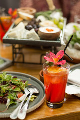 Red cocktail on a dining table, selective focus.