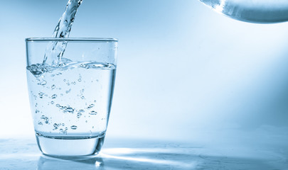 Drinking water is poured into a glass