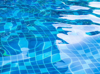 Background of rippled water in swimming pool / Blue ripped water in swimming pool