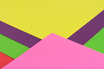 Colourful paper background red green pink violet and yellow colors