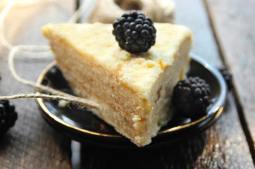 Cake and blackberries. cream.