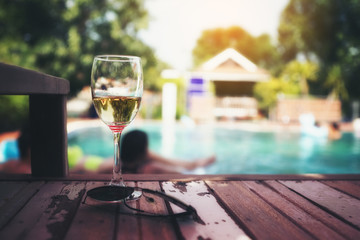 Friends having party  in a swimming pool. Young people are enjoying the holidays.