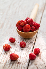 Strawberry in wood spoon  on the rustic board