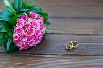 Bouquet of pink roses. Wedding ring. Copy space. The concept of a wedding, party, love and family.