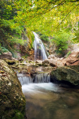 Obraz premium Beautiful autumn landscape with waterfall. Composition of nature