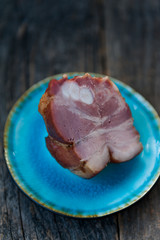 Smoked lamb meat on a blue plate