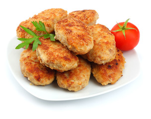 Homemade cutlets with tomato in white plate isolated on white background.