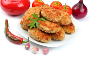 Homemade cutlets with tomato in white plate isolated on white background.