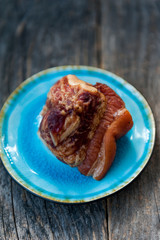 Smoked lamb meat on a blue plate