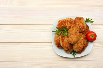 Homemade cutlets with tomato and broccoli on a wooden table. Healthy food. top view with copy space