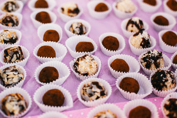 Little chocolates served on pink table