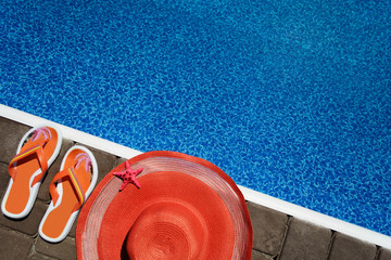 Summer accessories (hat, slaps) near the pool. With free blank space for your text.