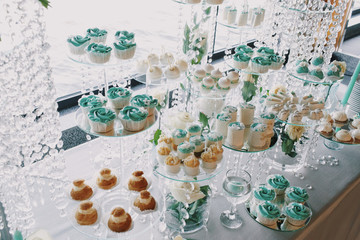 Delicious cupcakes and other bakarty covered with mint icing