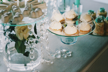 White sweets served on dinner table with crystal chains