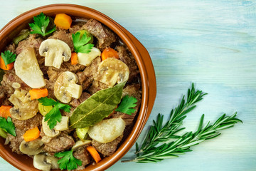 Overhead photo of meat and mushrooms ragout with copyspace