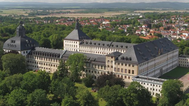 Drone view over historical "Schloss Friedenstein", Thuringia, Aerial view high above old German castle and the city Gotha, 4K 