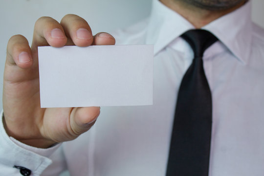 Businessman showing a business card.