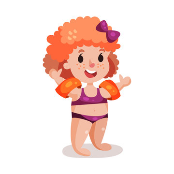 Cute happy redhead girl in purple swimsuit with inflatable armbands, kid ready to swim colorful character