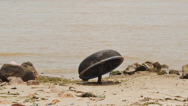The fisherman carries his boat ashore. Nha Trang is a city. Vietnam.
