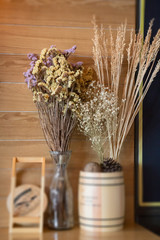 Ornamental basket of wheat on wooden table