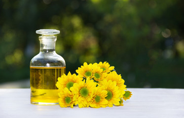 Essential floral oil. Flower elixir and fresh summer flowers. Spa and beauty care.