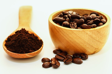 Roasted coffee beans and Crushed Coffee Powder with a white background