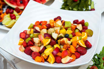 Salad with fresh fruits and berries. Bowl of healthy fresh fruit salad