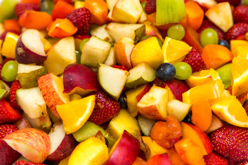 Salad with fresh fruits and berries Background. Bowl of healthy fresh fruit salad