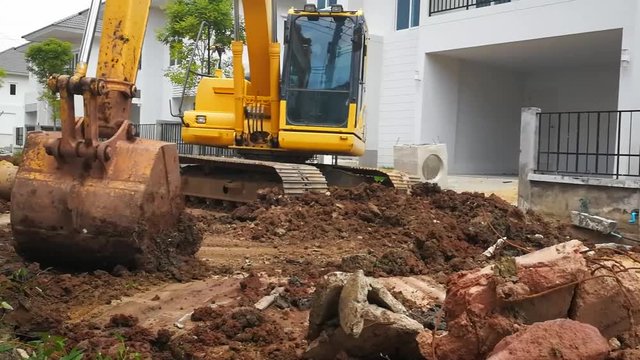 Makro digs or punches the car, Bangkok Thailand - July 31, 2017 : Giallo escavatore movimento terra e sabbia sul cantiere stradale in Thailand