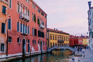 Fototapeta na wymiar Sunset time Venice: warm light, bright buildings, boats and bridges.