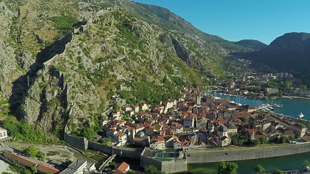 Aerial view above the old town of Kotor in Montenegro in the Bay of Kotor. Shooting from height, aerial photography. Flight over the city. Roof of houses in the city.