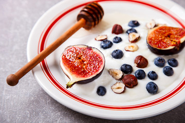 Yogurt with berries fresh figs, blueberries and honey.Food or Healthy diet concept.Super Food.selective focus.