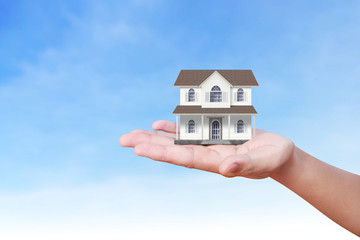 Mortgage concept by house from  hand