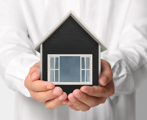 Mortgage concept by house from  hand