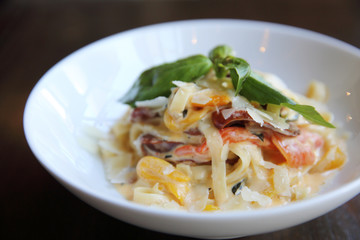 Chorizo sausage spaghetti fettuccine on wood background