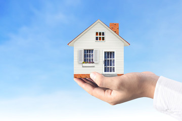 Mortgage concept by house from  hand
