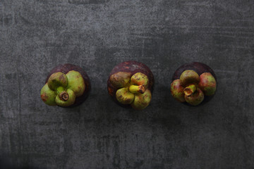 Mangosteen fruit on dark rock background