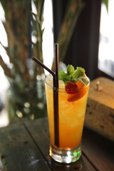 mai tai cocktail with orange cherry fruits on wood background